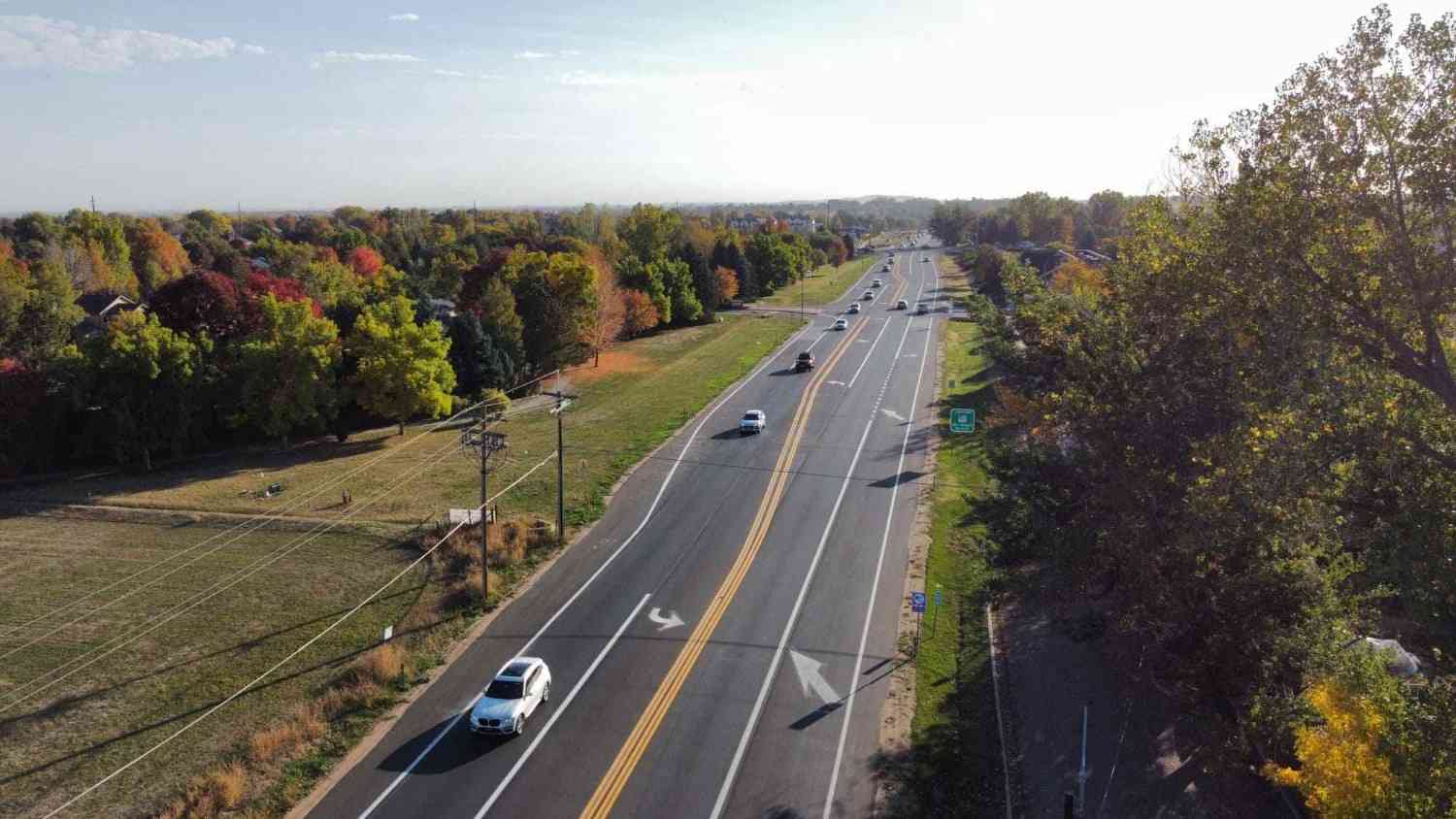 aerial-view-highway Street with moving vehicles and tree-lined sides in Denver, CO<br />
