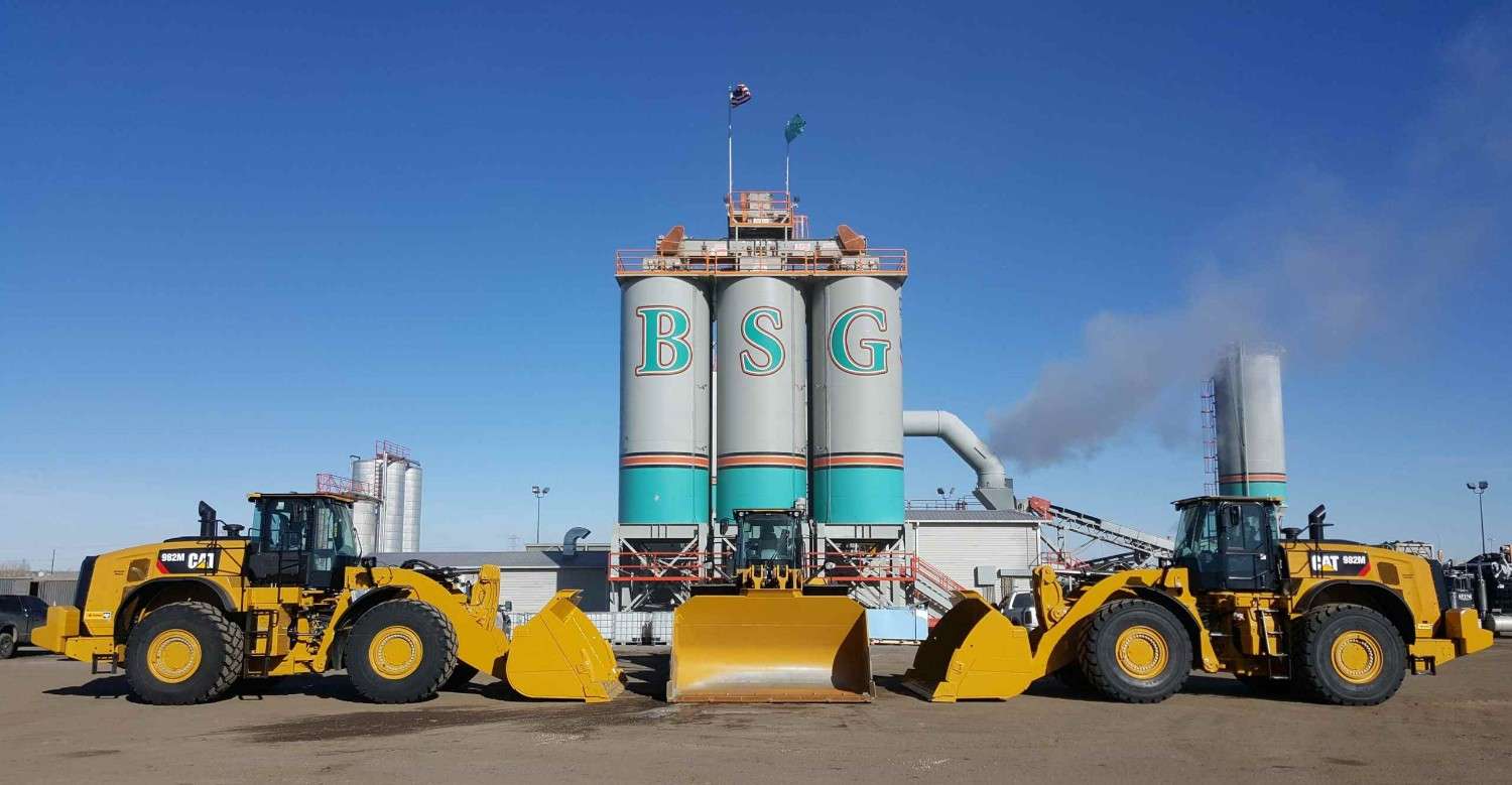 Asphalt materials facility with storage silos and loaders at the plant in Denver, CO<br />
