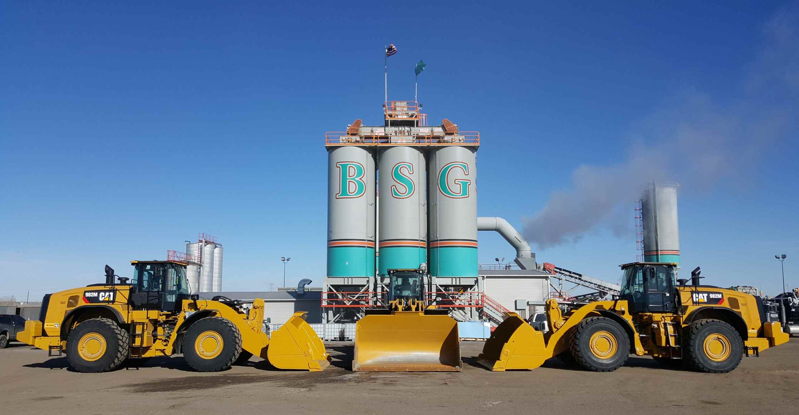 Asphalt materials facility with storage silos and loaders at the plant in Denver, CO<br />
