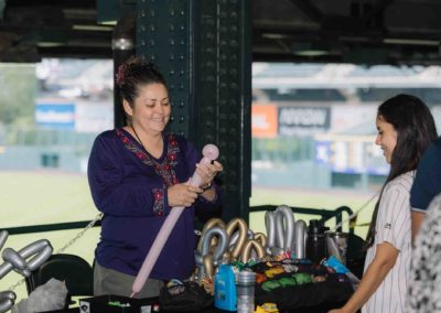Balloon artist making a balloon figure at the Brannan Company Picnic 2025 in Colorado