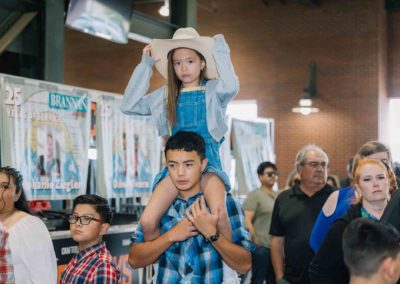 A boy carrying his sister on his shoulder at the Brannan Company Picnic 2025 in Colorado