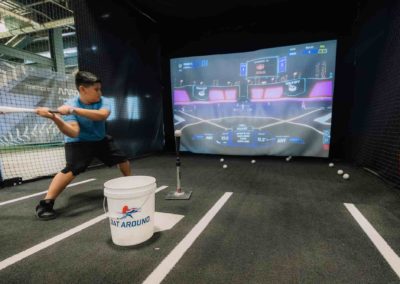 A boy playing baseball at the game station at Brannan Company Picnic 2025 in Colorado
