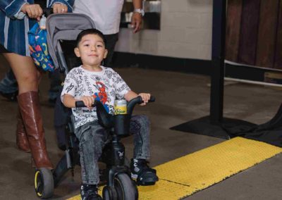 Child riding a tricycle at the Brannan Company Picnic 2025 in Colorado