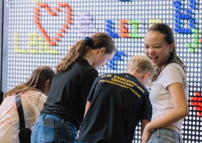 Employees gathered near the light display at the Brannan Company Picnic 2025 event in Denver, CO.