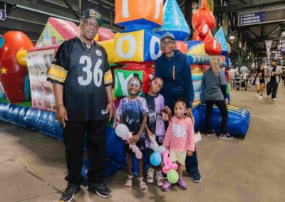 Family posing together after enjoying activities at the Brannan Companies picnic event in Denver