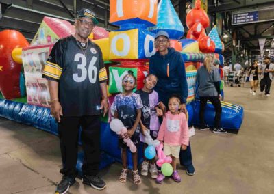 Family standing by a colorful inflatable at the Brannan Company Picnic 2025 in Colorado