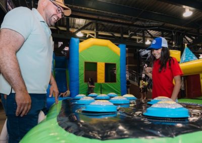 Father & daughter participating in a game during the Brannan Companies annual picnic in Denver, CO