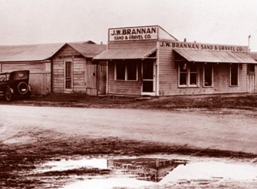 The old JW Brannan Office in Denver, CO, features a vintage car parked in front of the entrance