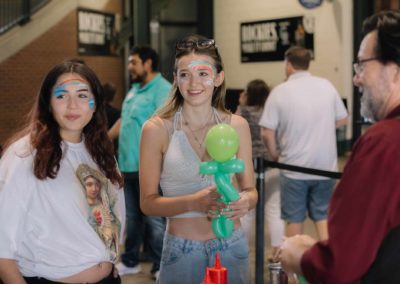 Two girls holding balloon art during the Brannan Companies Picnic 2025 in Colorado