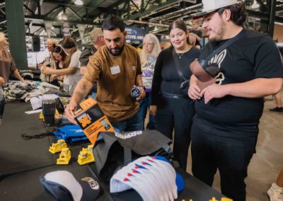 Guests browsing giveaway items at the Brannan Company Picnic 2025 in Colorado