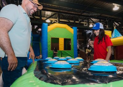 Man and daughter enjoying an interactive game during the Brannan Companies Picnic 2025 in Colorado