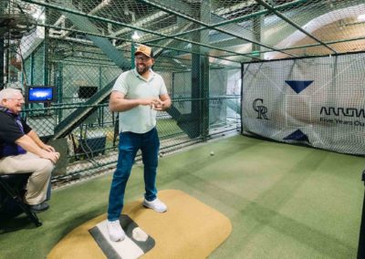 Team member enjoying batting practice at Brannan Company Picnic 2025 in Denver, CO.