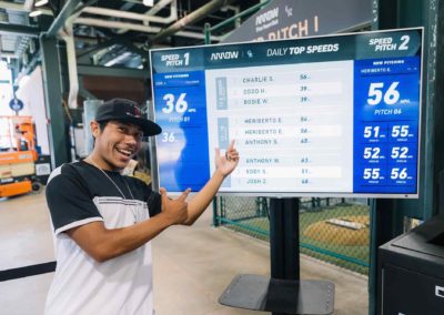 Man pointing at the speed pitch scoreboard during the Brannan Companies Picnic 2025 in Colorado