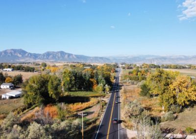 Aerial view of State Highway 7, with mountains in the background, near Denver, CO