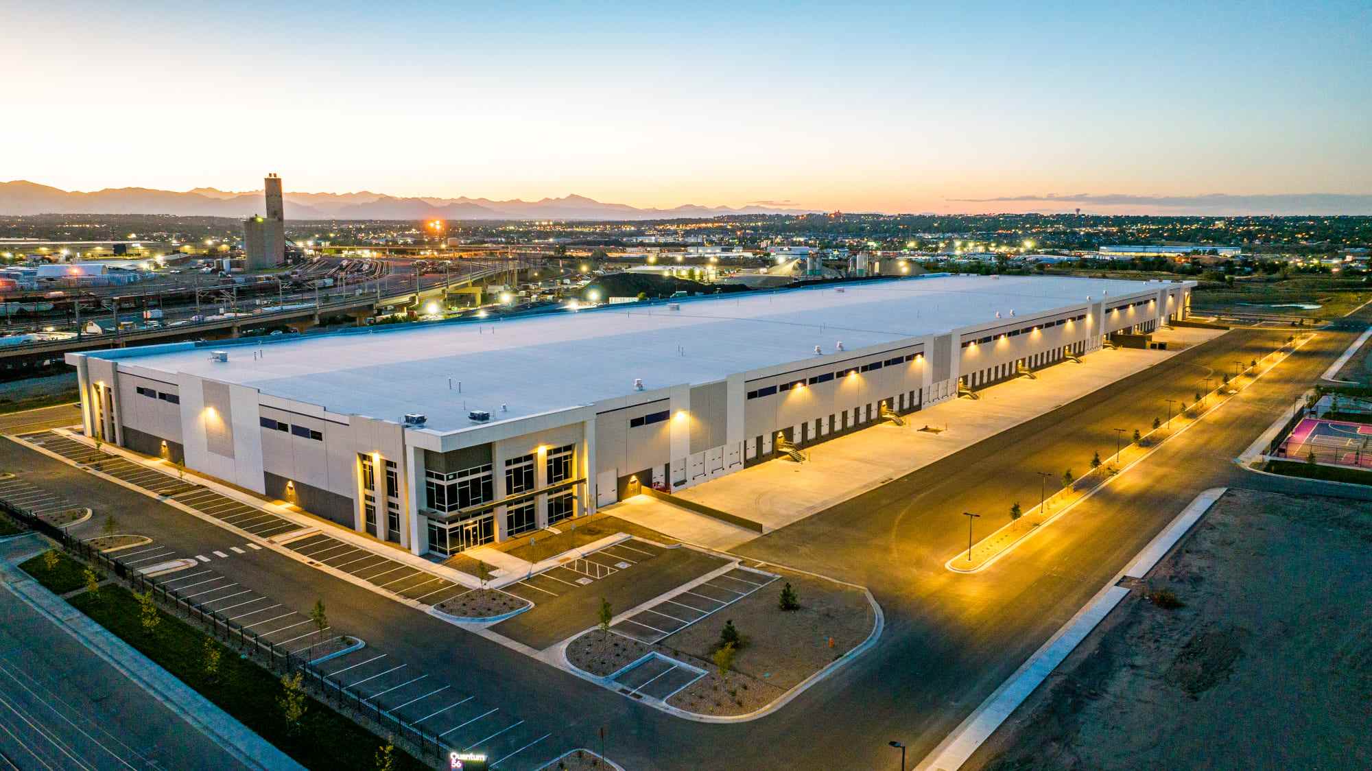 The Brannan Companies project showing a modern warehouse building at dusk in Denver, CO.