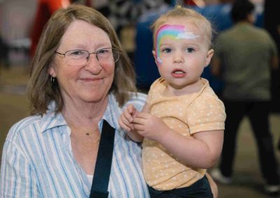 Woman holding a child at Brannan Company Picnic 2025 in Colorado