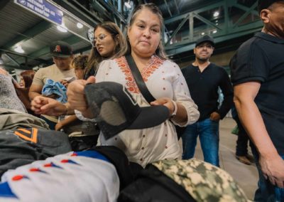 Woman picking up a cap during the Brannan Companies Picnic 2025 event in Colorado